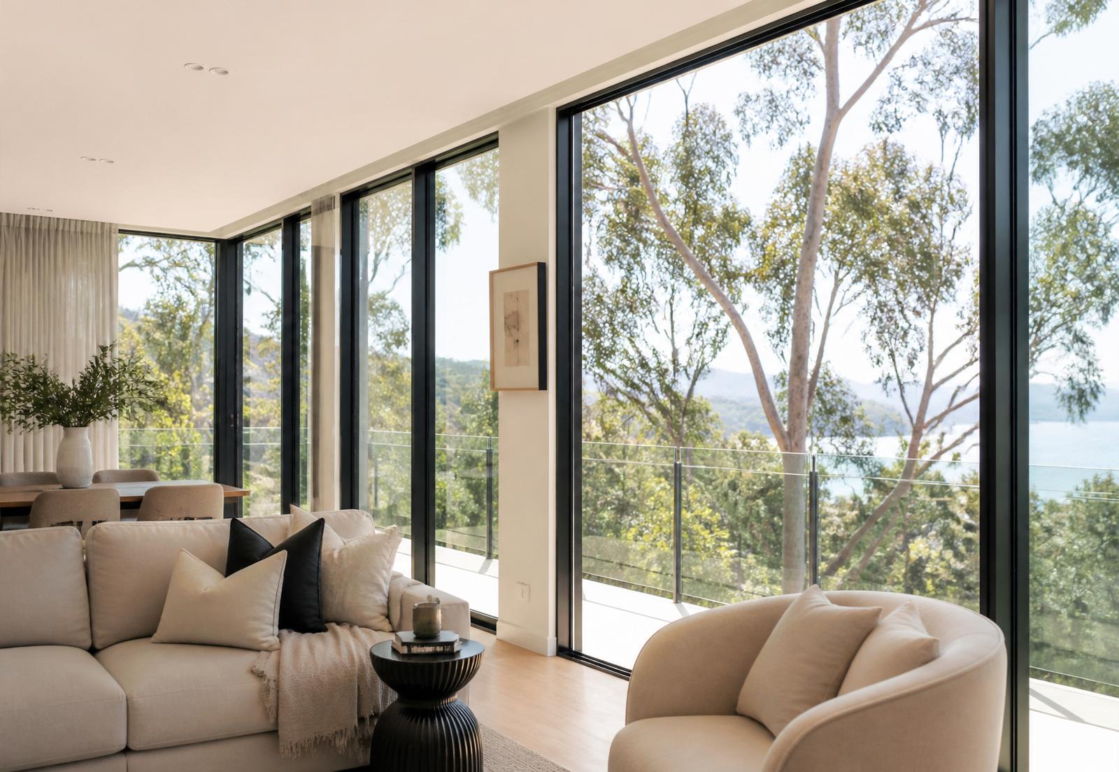 Sparkling floor-to-ceiling clean windows in a modern Australian home looking out to eucalyptus trees
